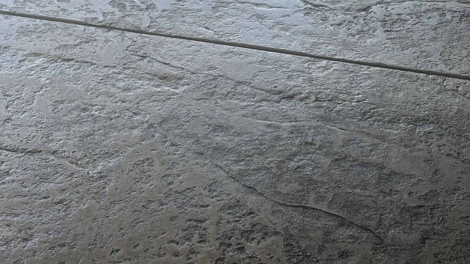 Wide view of a freshly stamped seamless-texture concrete slab