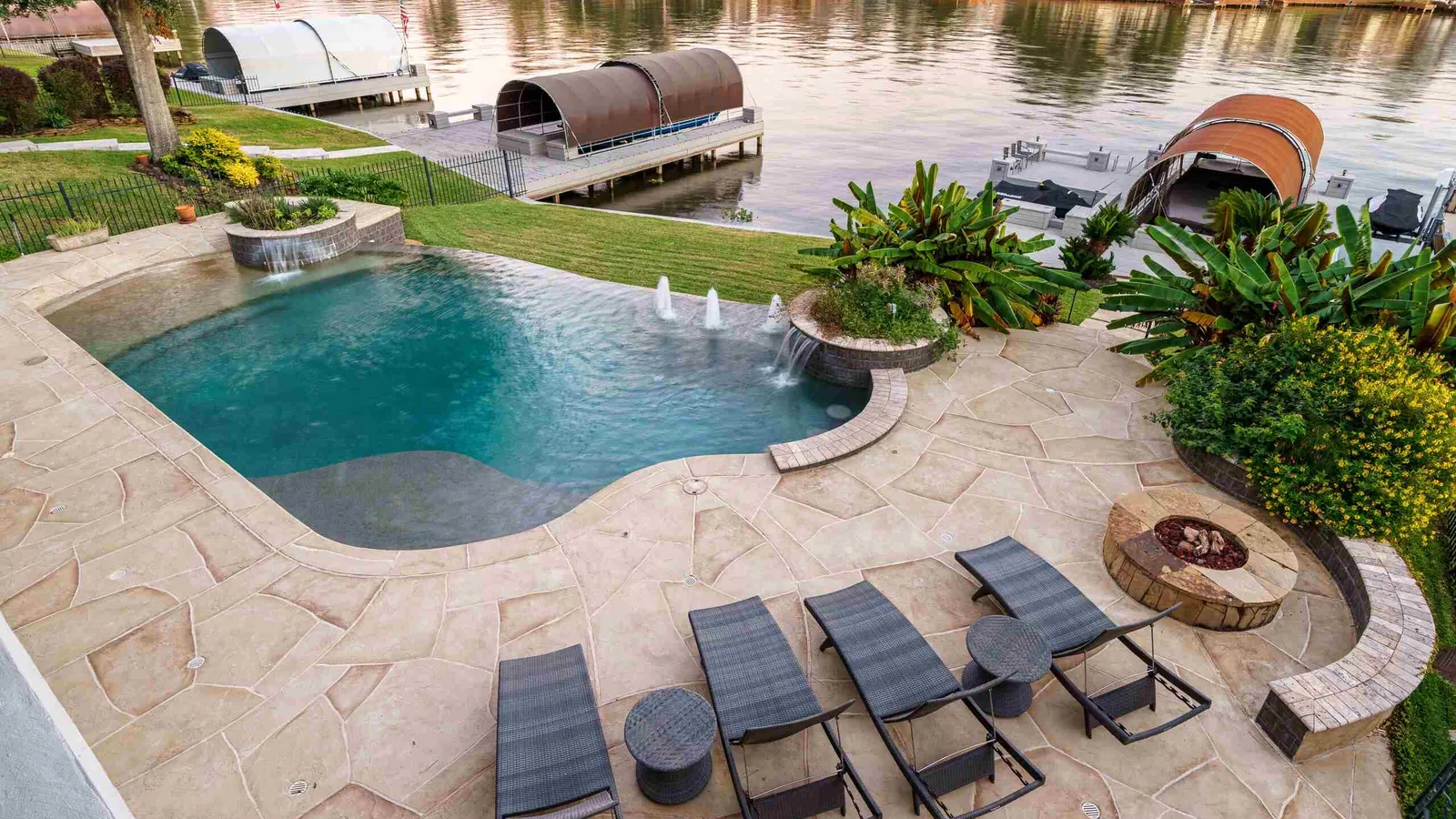 Textured concrete overlay pool deck resurfaced in a flagstone pattern around a swimming pool