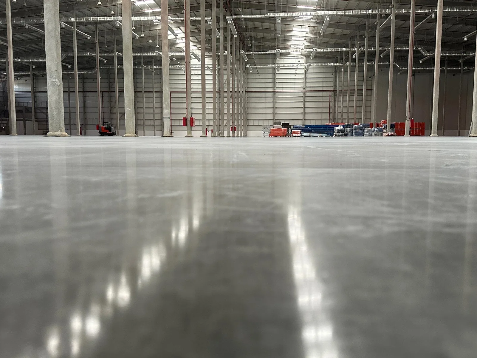 Finished polished concrete floor running the length of a warehouse