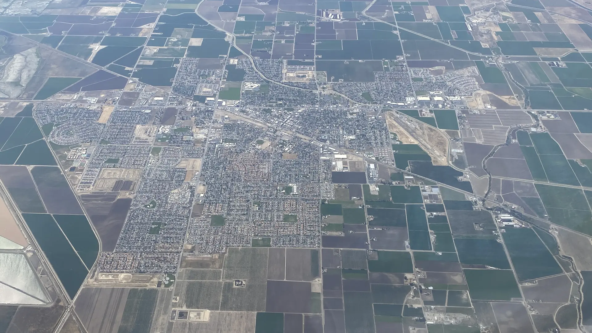 Aerial view of Los Banos, California, its neighborhoods ringed by farm fields on the west side of the San Joaquin Valley