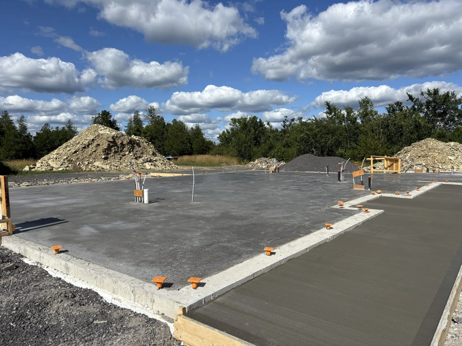 Poured slab-on-grade foundation with a thickened edge, anchor bolts and the forms still in place